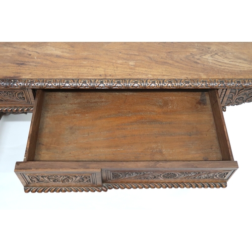 2000 - A 19TH CENTURY ANGLO-INDIAN LIBRARY TABLE rectangular top with carved foliate edges over pair of asy... 