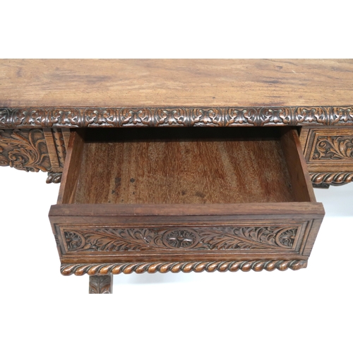 2000 - A 19TH CENTURY ANGLO-INDIAN LIBRARY TABLE rectangular top with carved foliate edges over pair of asy... 