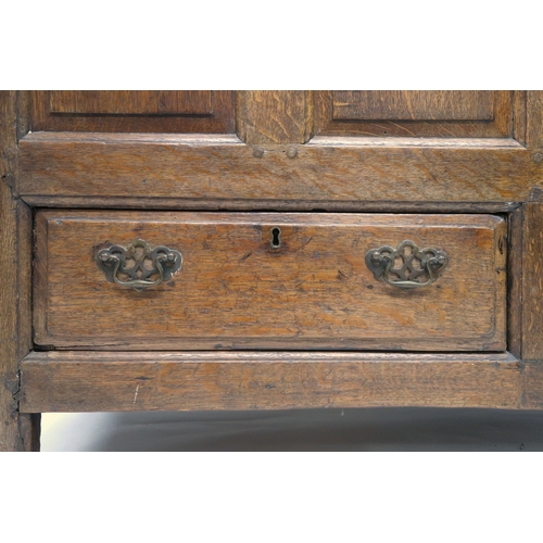 2007 - AN 18TH CENTURY OAK PANEL FRONT KIST with rectangular hinged top over panelled front over pair of dr... 