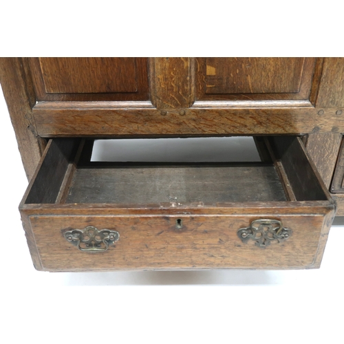 2007 - AN 18TH CENTURY OAK PANEL FRONT KIST with rectangular hinged top over panelled front over pair of dr... 