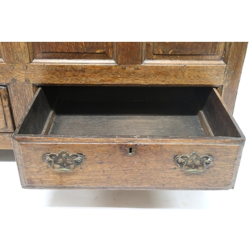 2007 - AN 18TH CENTURY OAK PANEL FRONT KIST with rectangular hinged top over panelled front over pair of dr... 