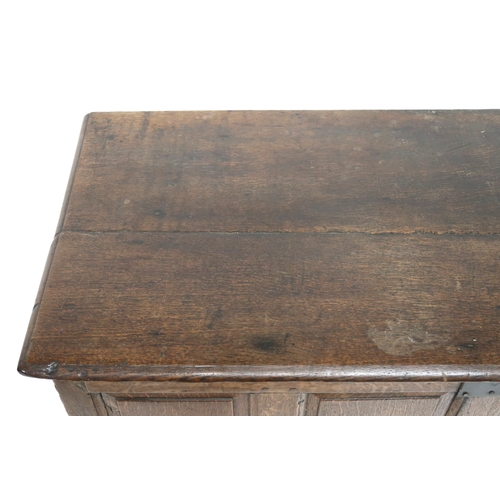 2007 - AN 18TH CENTURY OAK PANEL FRONT KIST with rectangular hinged top over panelled front over pair of dr... 