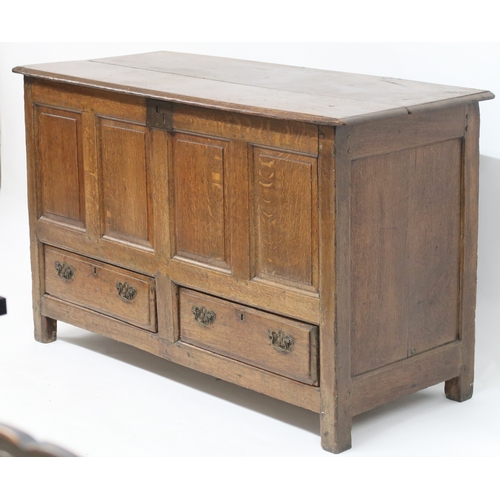 2007 - AN 18TH CENTURY OAK PANEL FRONT KIST with rectangular hinged top over panelled front over pair of dr... 