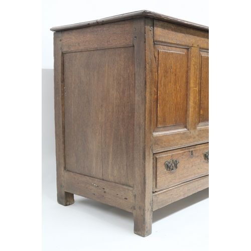 2007 - AN 18TH CENTURY OAK PANEL FRONT KIST with rectangular hinged top over panelled front over pair of dr... 