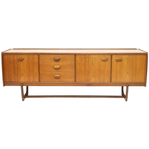 2103 - A MID 20TH CENTURY TEAK PORTWOOD SIDEBOARD with three drawers flanked by fall front drinks compartme... 