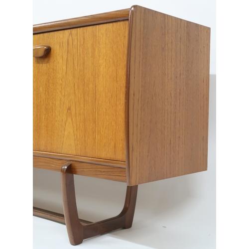 2103 - A MID 20TH CENTURY TEAK PORTWOOD SIDEBOARD with three drawers flanked by fall front drinks compartme... 