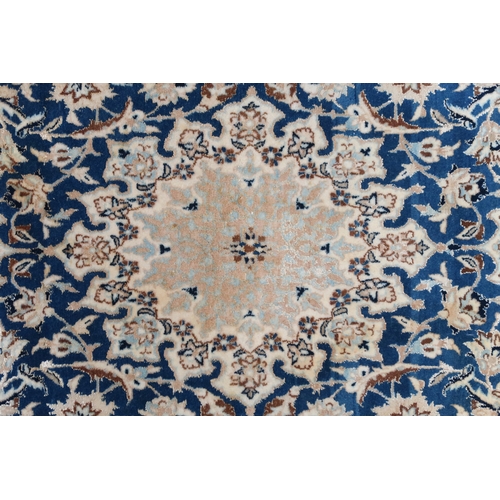 2170 - A DARK BLUE GOUND FINE PILE NAIN RUG mounted to bamboo wall rail with ivory and beige central medall... 