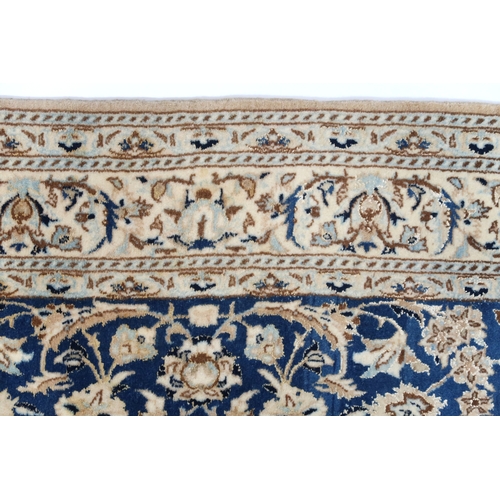 2170 - A DARK BLUE GOUND FINE PILE NAIN RUG mounted to bamboo wall rail with ivory and beige central medall... 