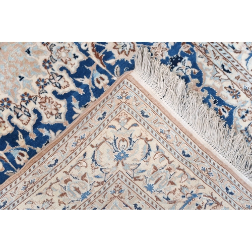 2170 - A DARK BLUE GOUND FINE PILE NAIN RUG mounted to bamboo wall rail with ivory and beige central medall... 