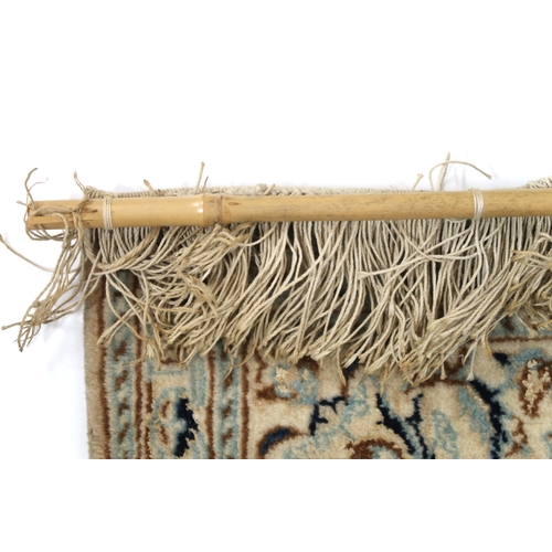 2170 - A DARK BLUE GOUND FINE PILE NAIN RUG mounted to bamboo wall rail with ivory and beige central medall... 