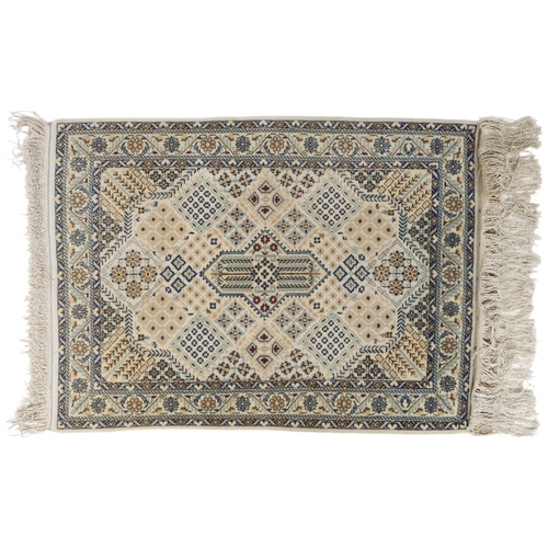 2172 - A CREAM GROUND FINE PILE NAIN RUG mounted to wall rail with floral/foliate patterned central medalli... 