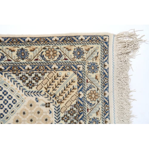 2172 - A CREAM GROUND FINE PILE NAIN RUG mounted to wall rail with floral/foliate patterned central medalli... 