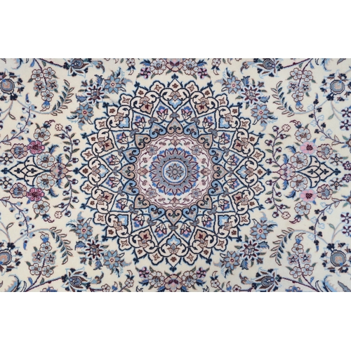 2174 - AN IVORY GROUND FINE PILE TABRIZ RUG with multicoloured sunburst central medallion and matching span... 