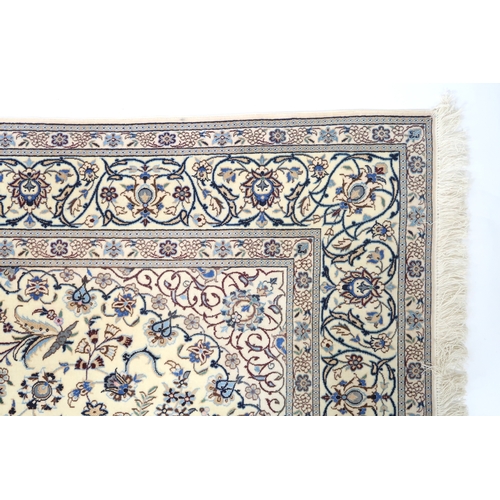 2174 - AN IVORY GROUND FINE PILE TABRIZ RUG with multicoloured sunburst central medallion and matching span... 