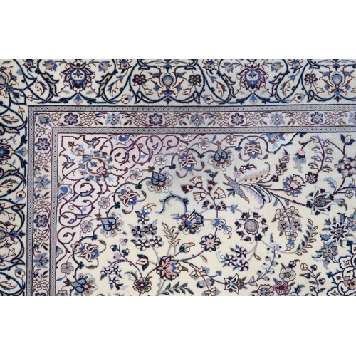 2174 - AN IVORY GROUND FINE PILE TABRIZ RUG with multicoloured sunburst central medallion and matching span... 