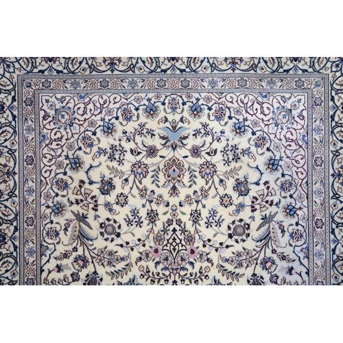 2174 - AN IVORY GROUND FINE PILE TABRIZ RUG with multicoloured sunburst central medallion and matching span... 