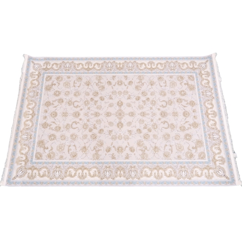 62 - AN IVORY GROUND FINE WOVEN FULL PILE IRANIAN CARPET with embossed allover floral design within ... 