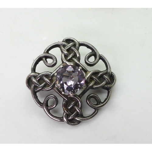 884 - A silver Celtic knot brooch, set with Amethyst, marked Thomas Kerr Ebbutt, Edinburgh, together with ... 