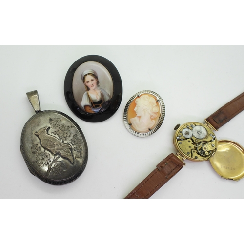 895 - A 9ct gold ladies watch head, together with a Silver bracelet, a large white metal locket with a bir... 