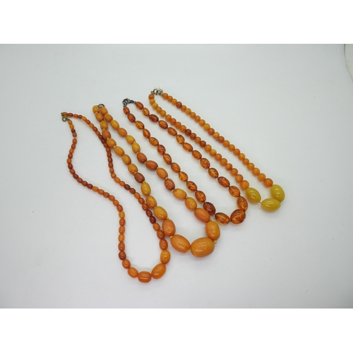 897 - Four strings of yellow Amber beads