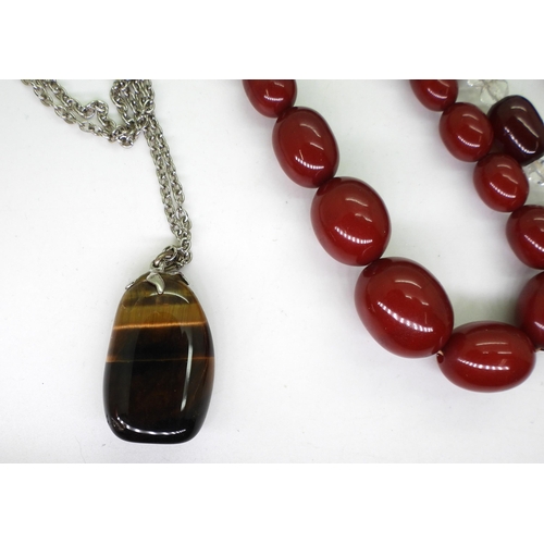 898 - Two strings of red cherry amber beads, together with further examples of gem-set beaded necklaces, i... 