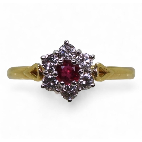 An 18ct ruby and diamond flower ring, set with estimated approx 0.30cts of brilliant cut diamonds, finger size M1/2, weight 2.3gms