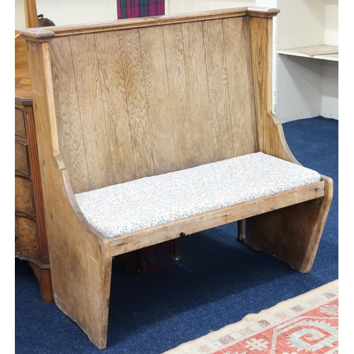 1 - An early 20th century pitch pine hall settle with corniced flat back over plain seat with loose cush... 