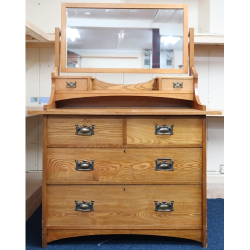 11 - An early 20th century oak Arts & Crafts mirror backed dressing chest with two over two drawers, ... 