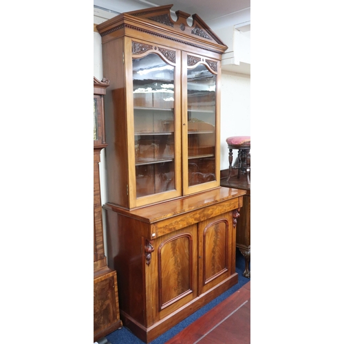 18 - A 19th century mahogany glazed library bookcase with carved architectural style cornice over pair of... 