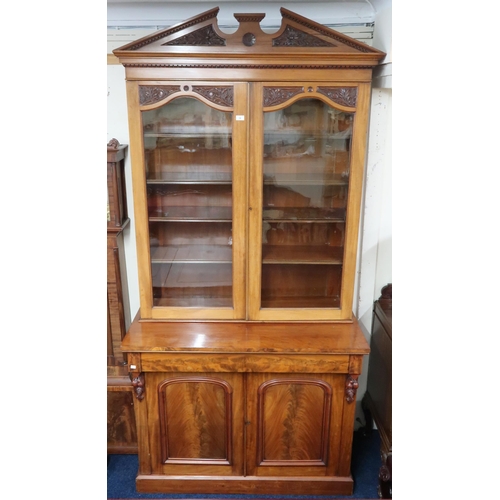 18 - A 19th century mahogany glazed library bookcase with carved architectural style cornice over pair of... 