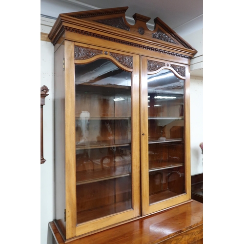 18 - A 19th century mahogany glazed library bookcase with carved architectural style cornice over pair of... 