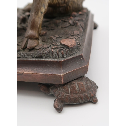 215 - A bronze model of Il Porcellino, after the antique, on a naturalistic base, the feet modelled as tur... 