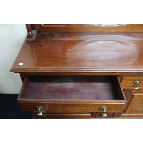 23 - A 20th century mahogany mirror backed sideboard with a pair of drawers over cabinet doors on turned ... 