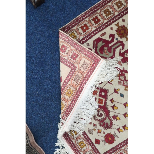 25 - A beige ground Kazak runner with multicoloured geometric patterned ground within multicoloured borde... 