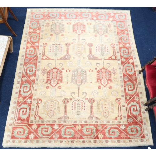 3 - A beige ground Kazak rug with multicoloured geometric patterned ground within terracotta border, 281... 