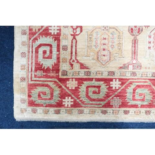 3 - A beige ground Kazak rug with multicoloured geometric patterned ground within terracotta border, 281... 