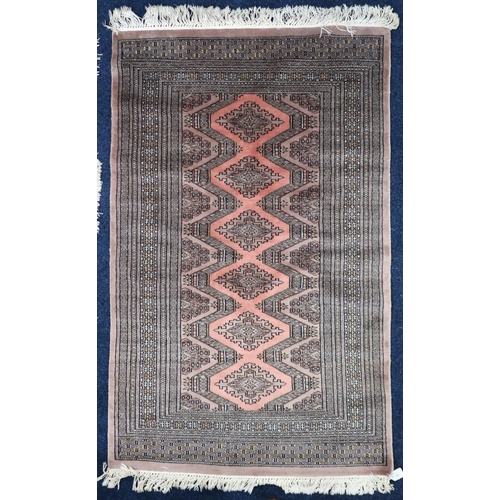 33 - A beige ground Bokhara style rug with geometric lozenge patterned ground within multiple borders, 14... 