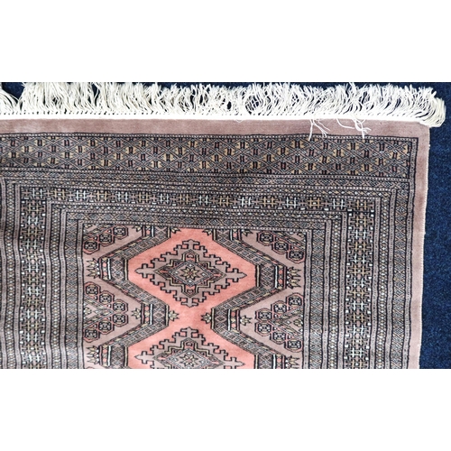 33 - A beige ground Bokhara style rug with geometric lozenge patterned ground within multiple borders, 14... 