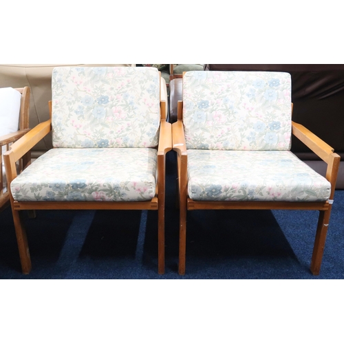 50 - A pair of mid 20th century Centa teak framed armchairs with rail backs and floral upholstered cushio... 