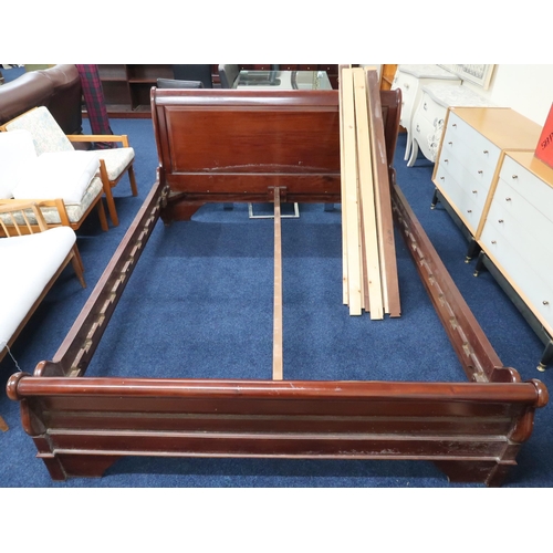 68 - A contemporary dark stained framed sleigh bed, 98cm high x 170cm wide x 225cm long 