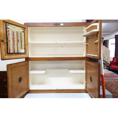 71 - A late 19th/early 20th century Hygena larder/kitchen cabinet with two pairs of cabinet doors over sl... 