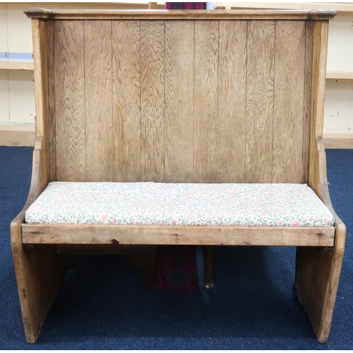 1 - An early 20th century pitch pine hall settle with corniced flat back over plain seat with loose cush... 