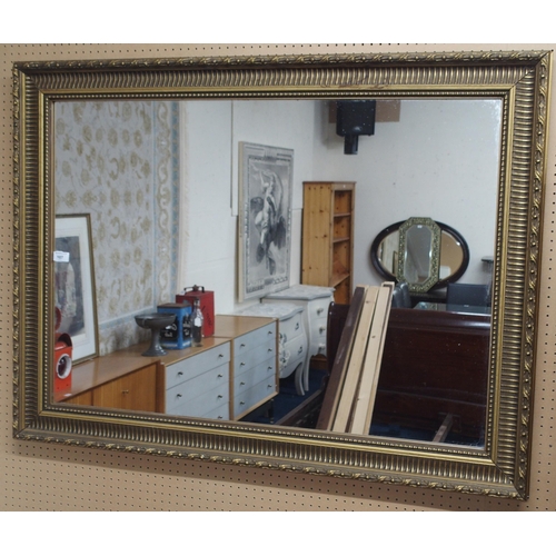 107 - A 20th century gilt framed rectangular wall mirror, 90cm high x 120cm wide 