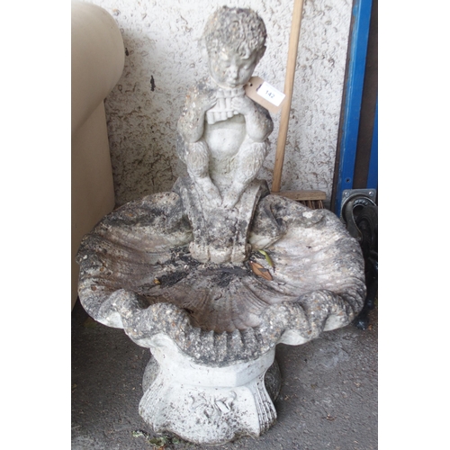 142 - A 20th century reconstituted stone garden birdbath modelled with a pan flute playing satyr over a sc... 