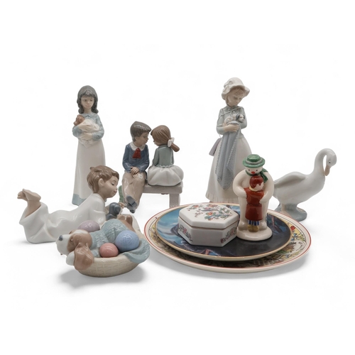 203 - A collection of Nao figures including girl holding puppy, dog, Royal Doulton Thank You Snowman, a Fr... 