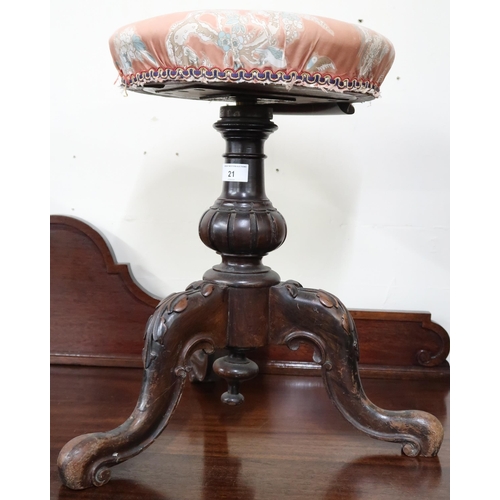 21 - A Victorian walnut adjustable piano stool with circular upholstered seat on turned pedestal support ... 