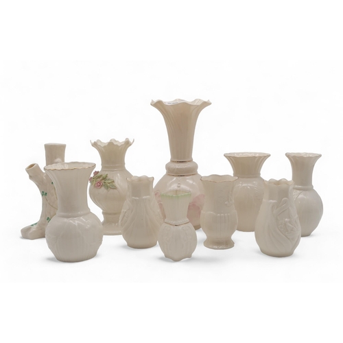 212 - A collection of Belleek, including Collector's Society vases, a 6th mark vase modelled as a tree, an... 