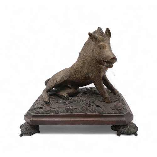 215 - A bronze model of Il Porcellino, after the antique, on a naturalistic base, the feet modelled as tur... 