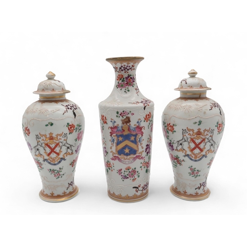 231 - A pair of Samson armorial vases and covers, in the Chinese export style, along with another vase, wi... 