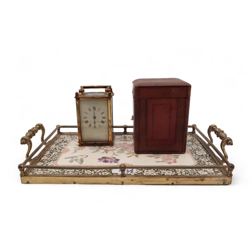 243 - A cased brass carriage clock and a transfer printed tray (2)